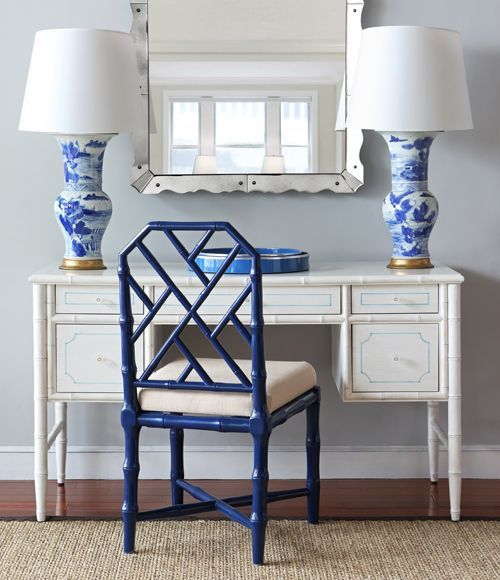 a blue and white desk with two lamps on it