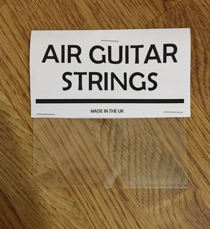 an air guitar strings label on a wooden table