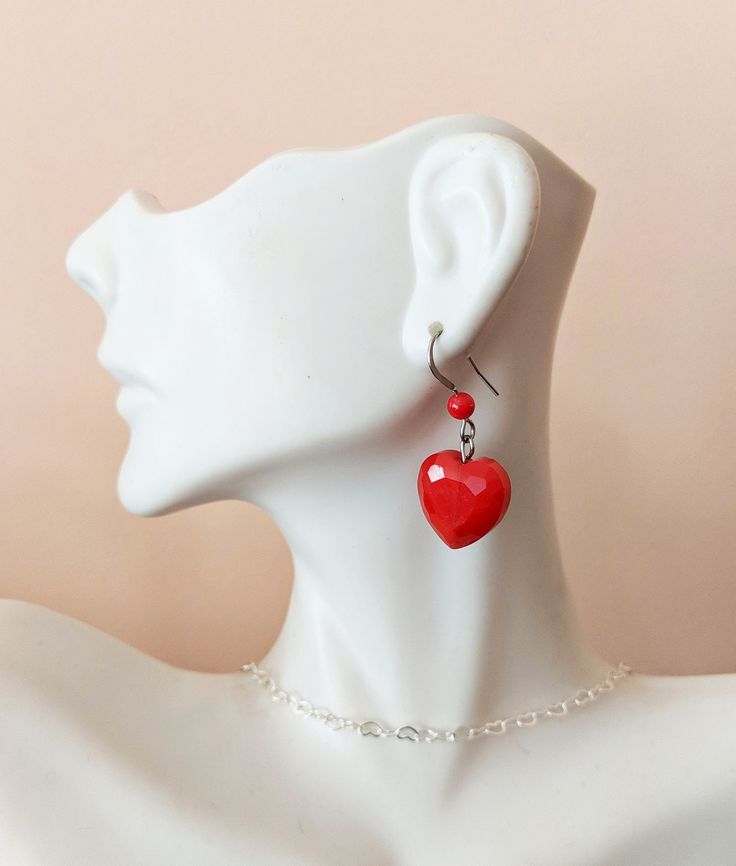 "Give this lovely earrings to yourself or to someone special! They are perfect for Valentine's Day or any special occasion. Featuring 14mm red glass heart shape beads and  4mm coral bamboo round beads. Silver plated findings. Measures 1 inch long  from top of ear wire to bottom of heart. The second pair of earrings features dangle made of heart shape glass beads and a 6 mmm glass bead. The total length is about 1.5 inch. This type of earrings come in 2 colors: red and purple. All earrings are at Cheap Heart-shaped Earrings With Heart Beads, Red Heart-shaped Hypoallergenic Jewelry, Red Hypoallergenic Heart-shaped Jewelry, Adjustable Red Heart Earrings For Gift, Adjustable Heart Earrings For Valentine's Day, Red Double Heart Earrings With Heart Beads, Elegant Heart Beads Earrings For Valentine's Day, Adjustable Heart Charm Earrings For Valentine's Day, Valentine's Day Earrings With Heart Charm