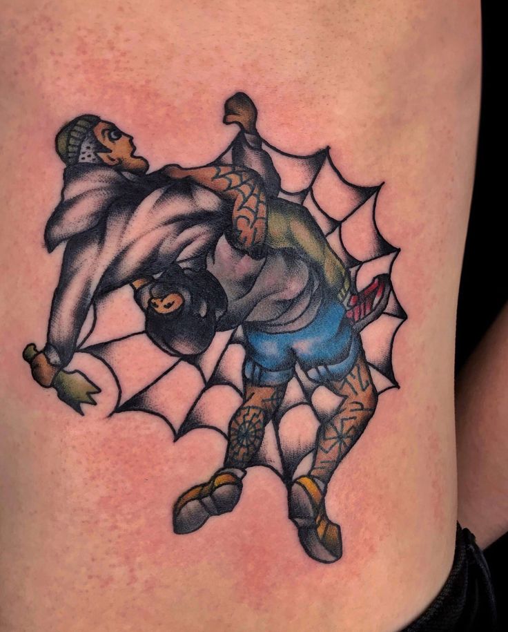 a man with a spider web tattoo on his thigh