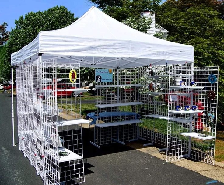 a white tent with several cages around it