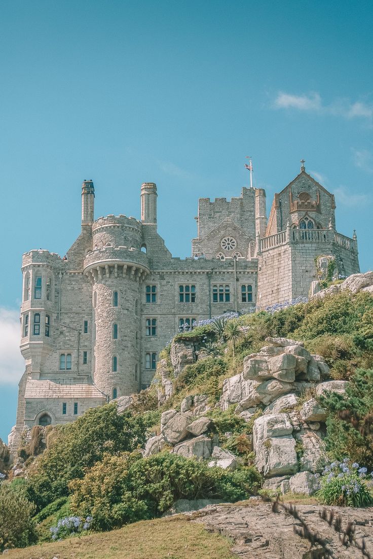 an old castle sitting on top of a hill