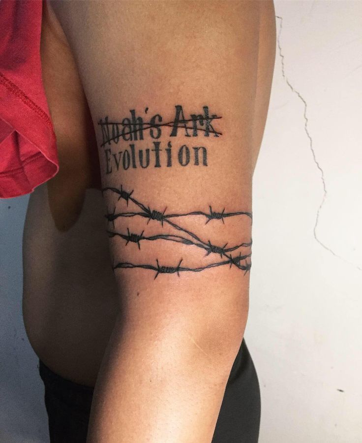 a man's arm with barbed wire and the words, there is art evolution on it