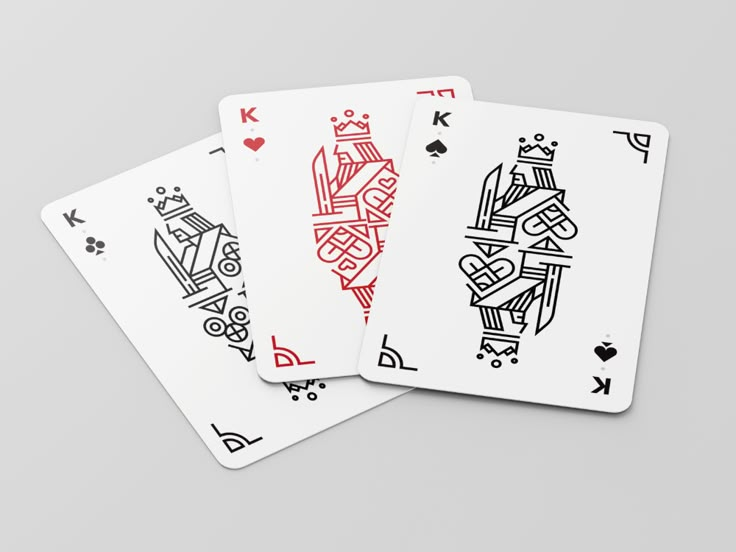 three playing cards with different designs on them