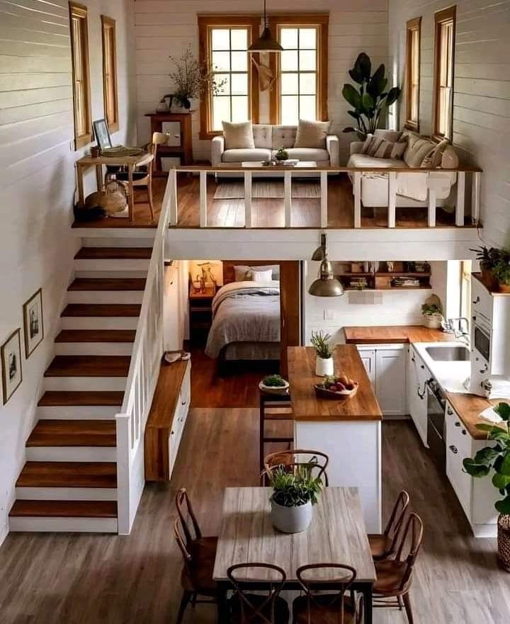 an open floor plan with stairs leading up to the loft