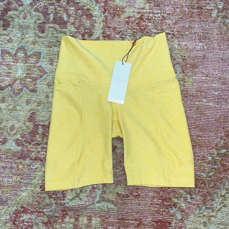 a pair of yellow shorts sitting on top of a rug