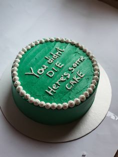 there is a green cake on the table