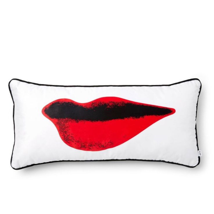 a white pillow with red lips on the front and black trim around the edges, against a white background