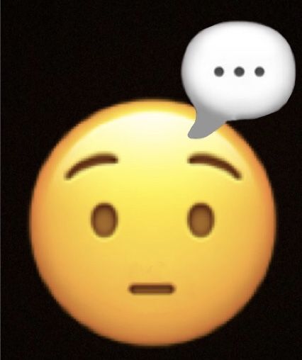 an emoticive smiley face with a speech bubble above it's head in the dark