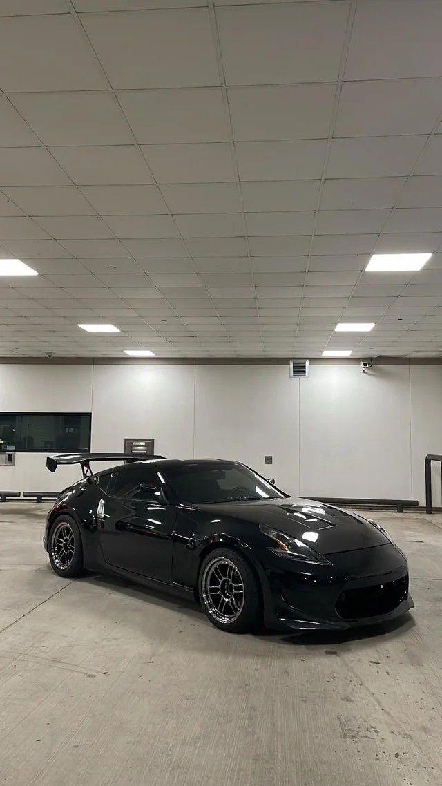 a black sports car parked in a parking garage