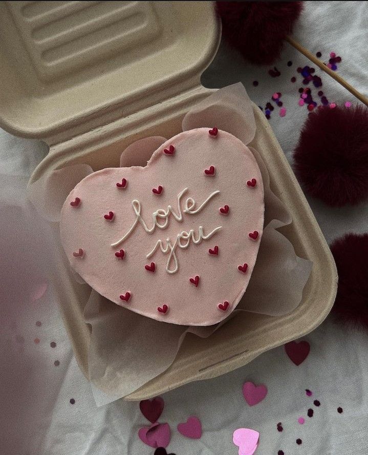 a heart shaped cake in a box with the words i love you written on it