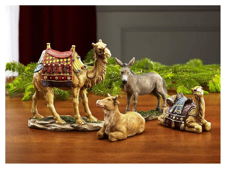 three figurines of animals sitting on a table