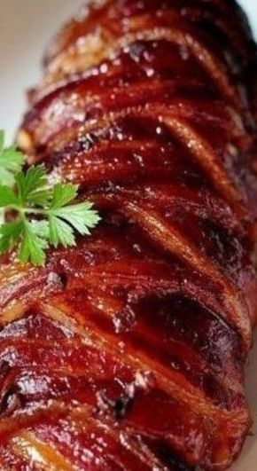 bacon wrapped in sauce and garnished with parsley