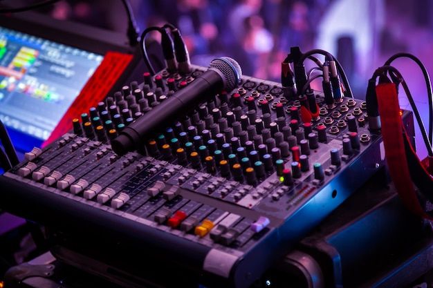 the sound board is set up with microphones and headphones on top of it