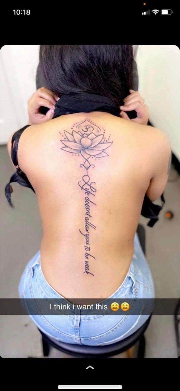 the back of a woman's neck with tattoos on it