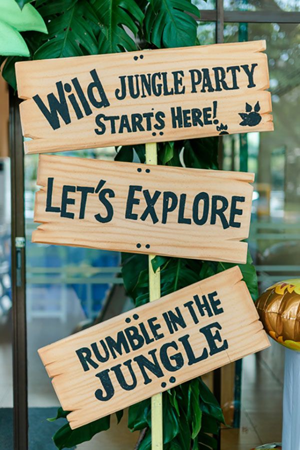 there are signs that say jungle party starts here and let's explore rumble in the jungle