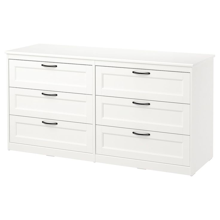 a white dresser with four drawers and two doors