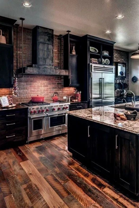 a kitchen with an oven, stove and refrigerator in it's center island surrounded by wooden flooring