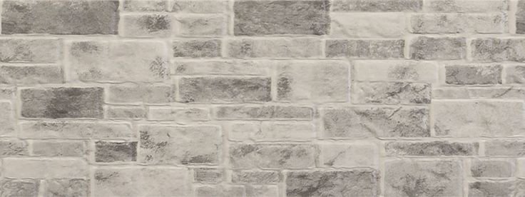 a white brick wall that is made out of grey bricks