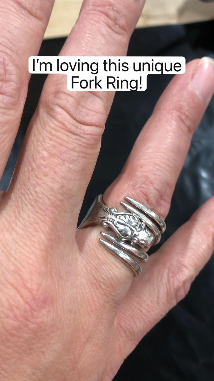 a woman's hand with two rings on it and the words i'm loving this unique fork ring