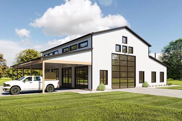 a white truck is parked in front of a large garage with windows on the side