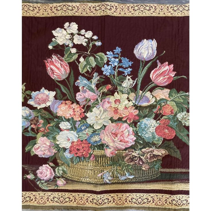 a painting of flowers in a basket on a table cloth with an ornate border around it