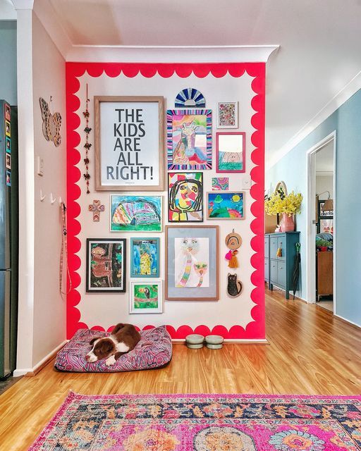 a dog laying on its bed in front of a colorful wall