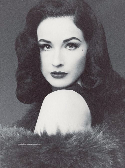 black and white photograph of a woman with long dark hair wearing a fur stole over her shoulder