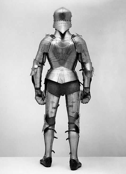 an old photo of a man in armor and helmet standing with his hands on his hips