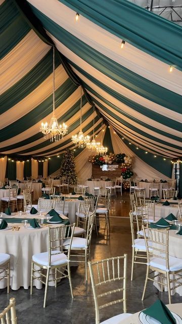 the inside of a tent with tables and chairs