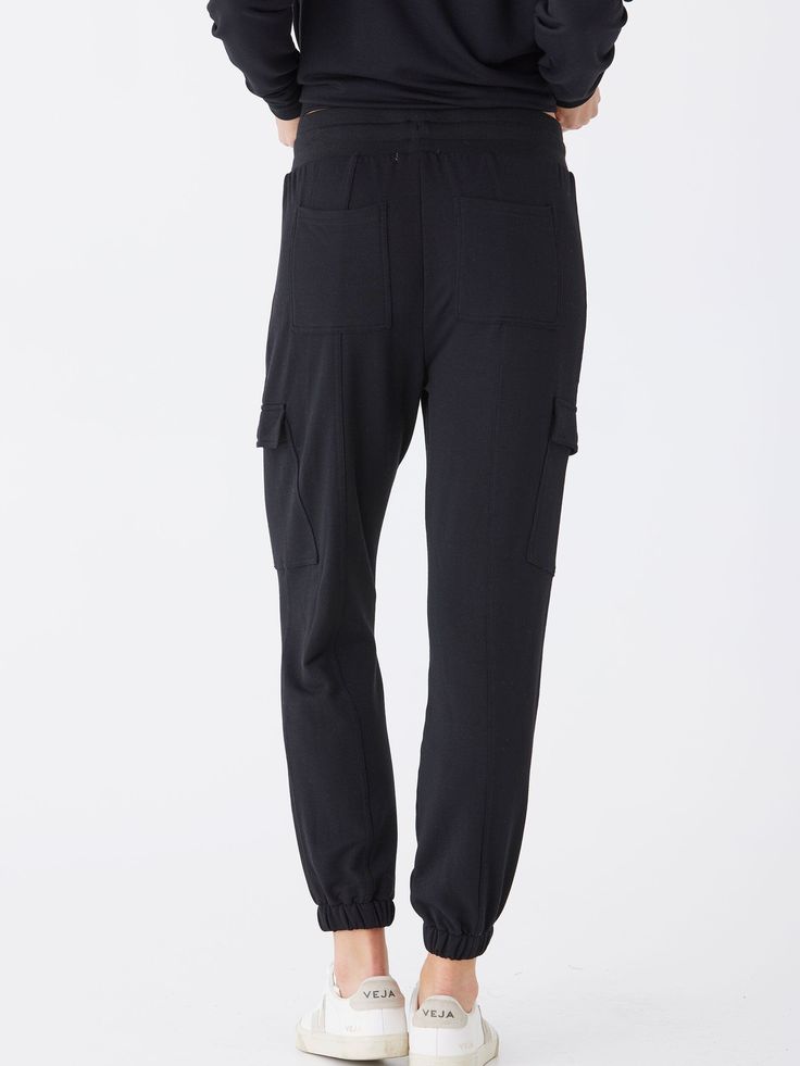 Indulge in ultimate comfort with Margot Modal Terry Cargo Jogger. Featuring a soft, wide elastic waistband for all-day comfort, and convenient cargo pockets for added functionality. Elevate your loungewear game with these joggers and experience a new level of relaxation. Versatile Activewear With Pockets For Loungewear, Comfort Stretch Black Sweatpants With Pockets, Black Comfort Stretch Sweatpants With Pockets, Functional Activewear With Pockets For Loungewear, Casual Yoga Activewear With Side Pockets, Casual Activewear For Yoga With Side Pockets, Utility Style Sweatpants For Loungewear, Stretch Bottoms With Cargo Pockets For Loungewear, Athleisure Cargo Pants With Elastic Waistband