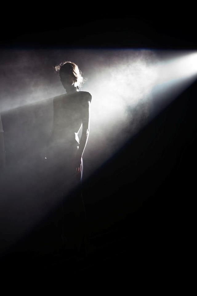 a man standing in front of a spotlight