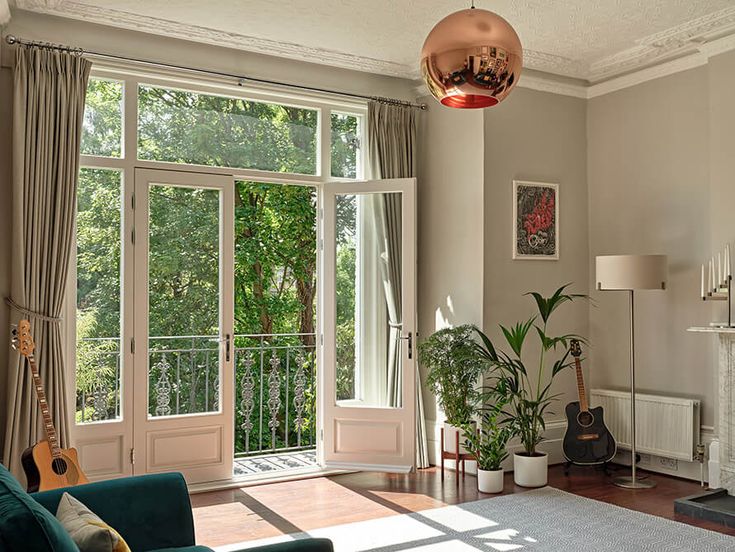 a living room filled with furniture and a fire place in front of a large window