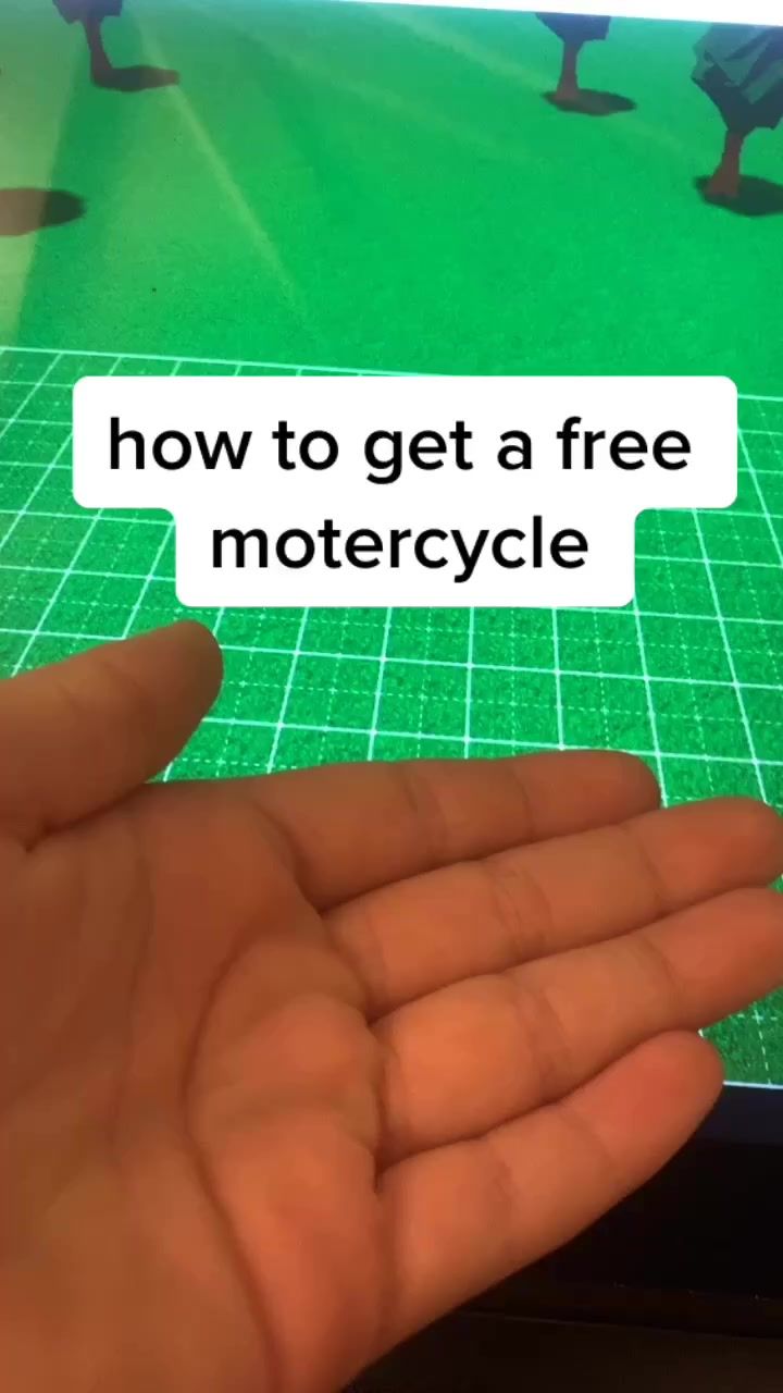 someone is holding their hand out to show the text how to get a free motorcycle