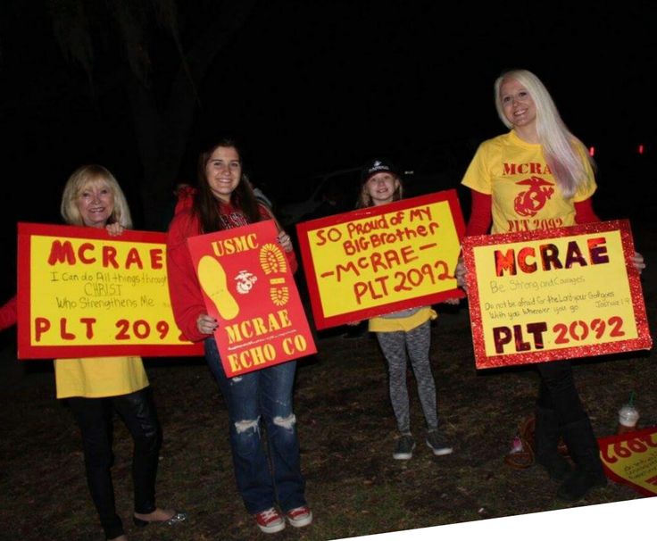 some people holding up signs in the dark