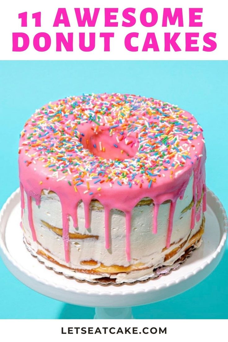 a cake with pink frosting and sprinkles on top, sitting on a plate