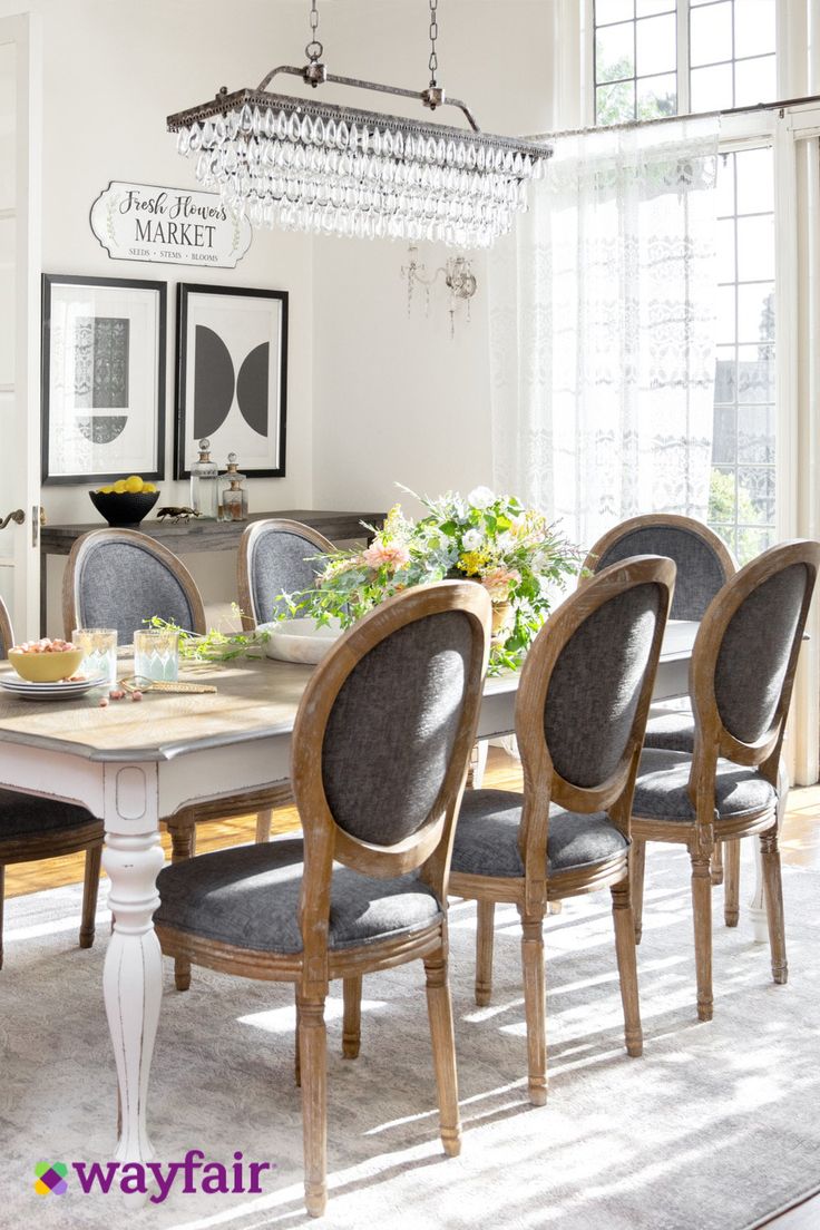 a dining room table with chairs and chandelier