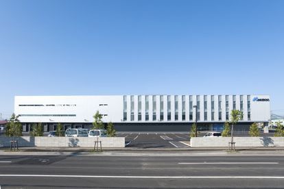 an empty street in front of a large white building