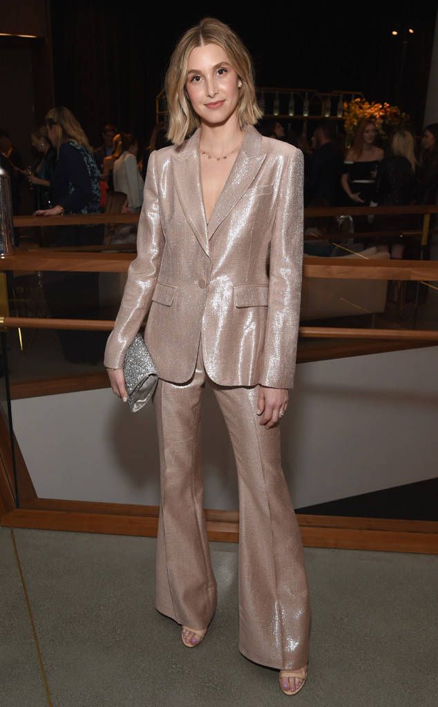 a woman in a metallic suit posing for the camera