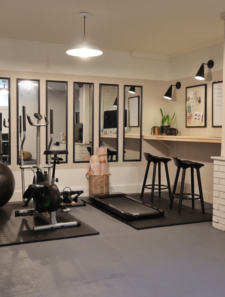 a home gym with exercise equipment and stools