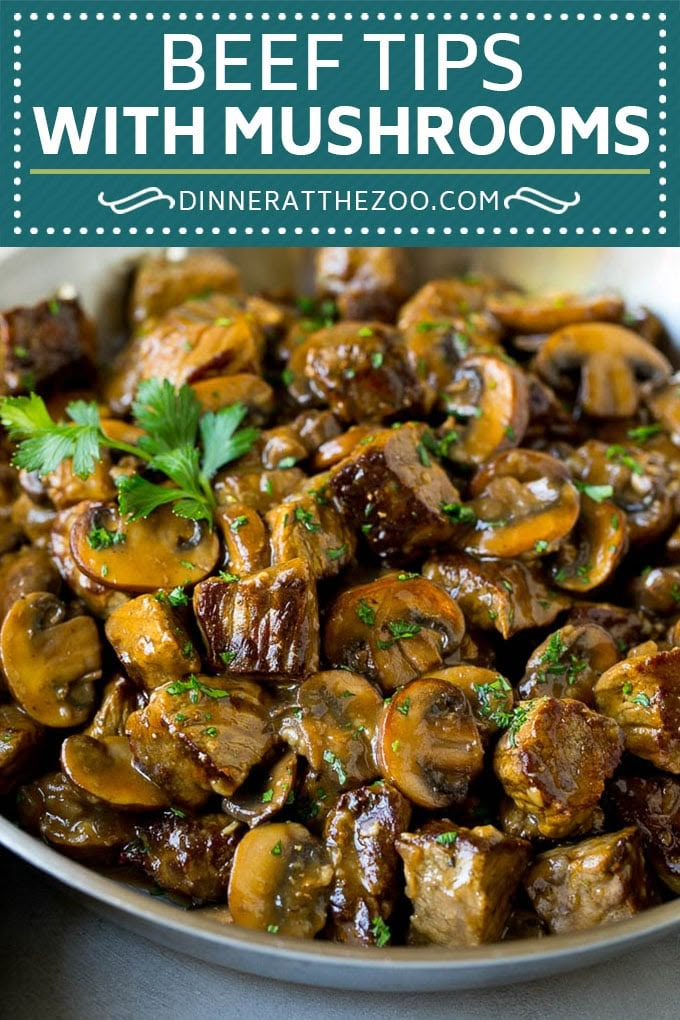 beef tips with mushrooms in a white bowl, garnished with fresh parsley