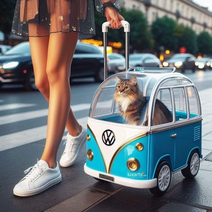 a cat sitting in a blue and white vw bus shaped luggage bag on the street