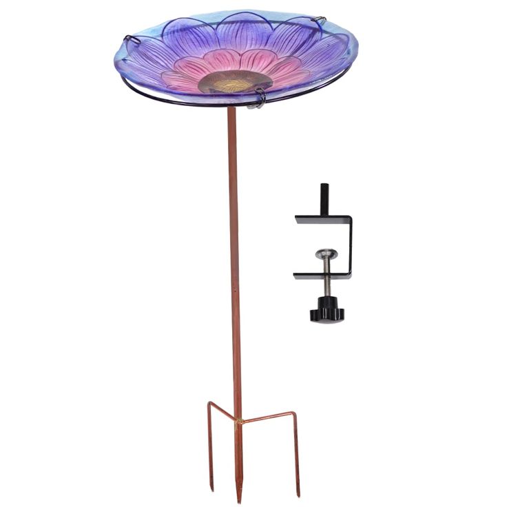 a purple flower on a metal stand with a light in the middle and an object hanging from it's side