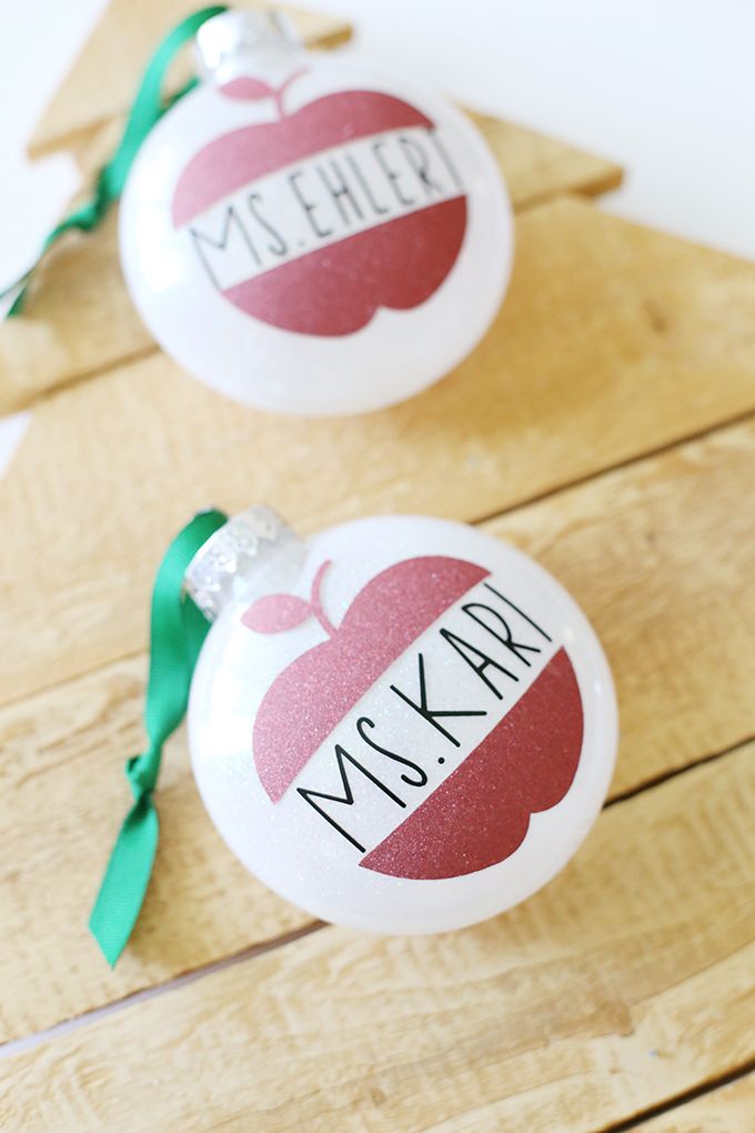 two personalized christmas ornaments on wooden boards