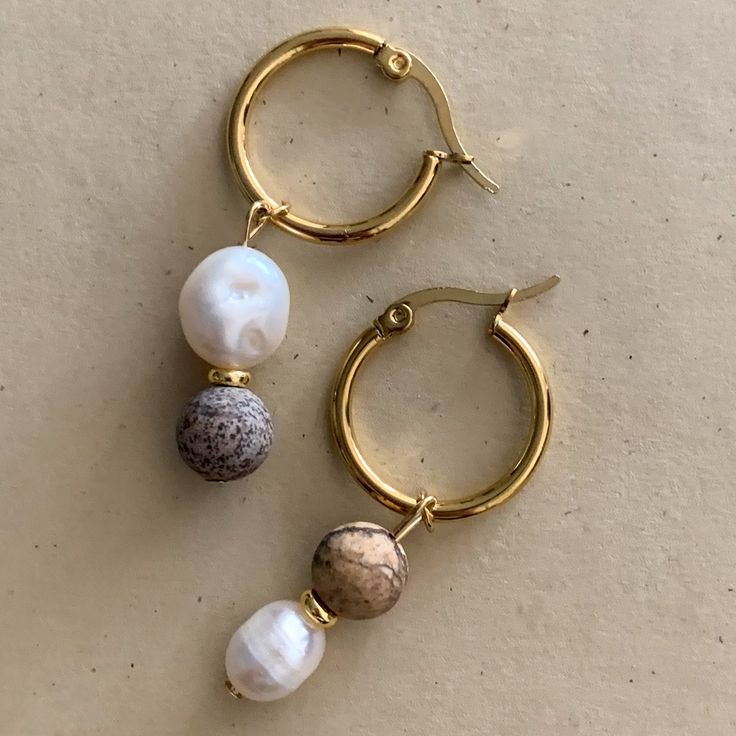 Just like Earth herself, Gisele earrings are fresh and natural. *Due to the organic shape of nature, the freshwater pearls can differ in size shown on image.* Care Store jewelry in microfiber Club Paradiso pouch. To clean, use microfiber pouch to wipe away dirt and oil buildup. Avoid contact with chemicals (lotions, perfumes, etc) to prevent fading. Material Gold plated brass with freshwater pearls and organic stone. RETURNS Although we do not accept returns. We will make an exception on case by Gold Natural Stones Earrings Nature-inspired, Gold Nature-inspired Earrings With Natural Stones, Nature-inspired Gold Earrings With Natural Stones, Gold Earthy Everyday Earrings, Earthy Gold Drop Earrings, Earthy Gold Everyday Earrings, Natural Stone Dangle Pearl Earrings, Teardrop Pearl Earrings With Natural Stones, Gold Natural Stones Drop Pearl Earrings