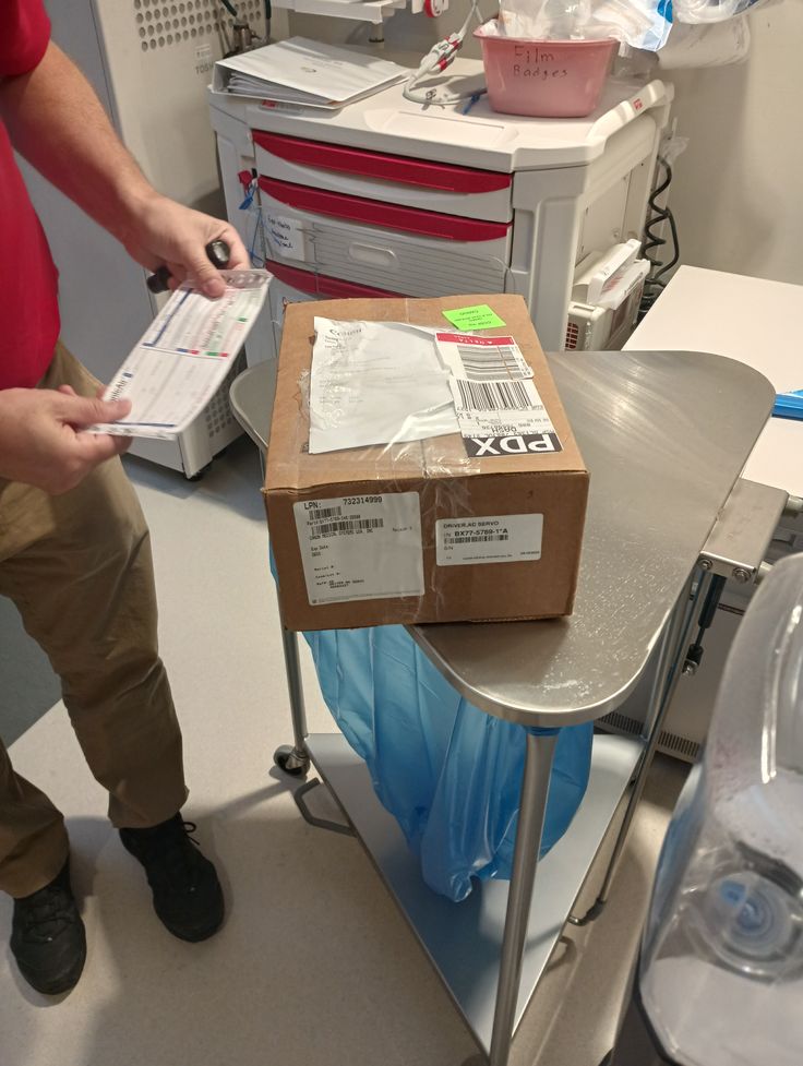 a person standing next to a table with boxes on it