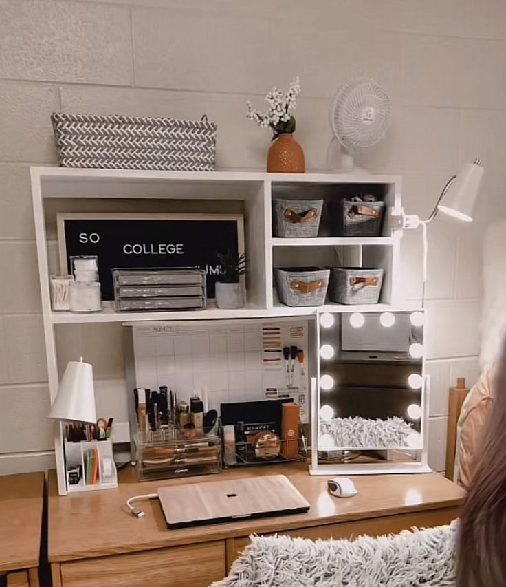 a woman sitting in front of a desk with a mirror