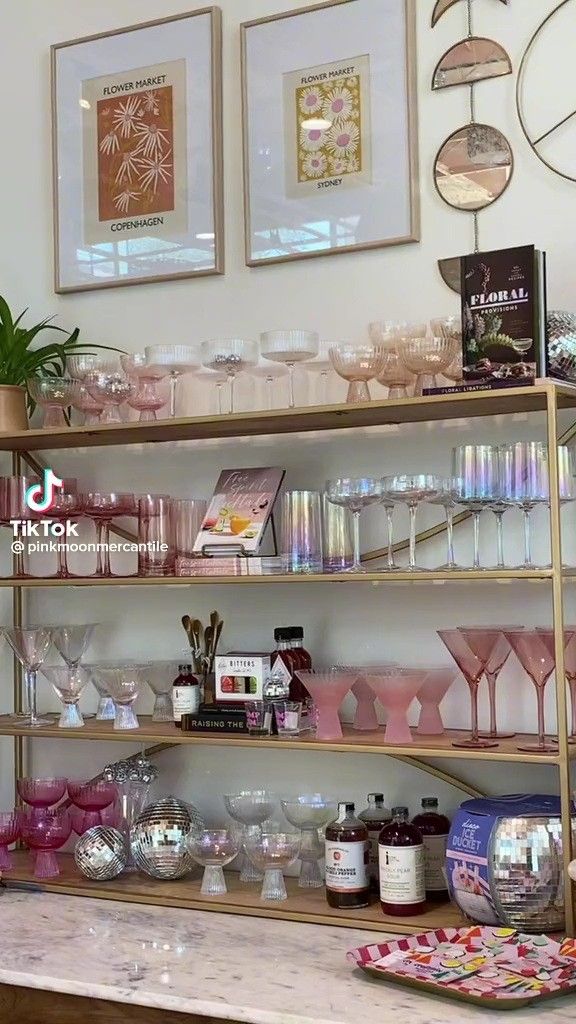 a shelf filled with lots of bottles and glasses