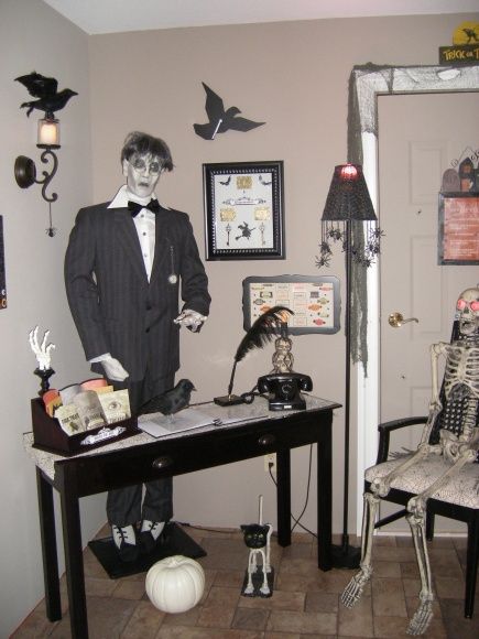 a room decorated for halloween with skeletons and decorations