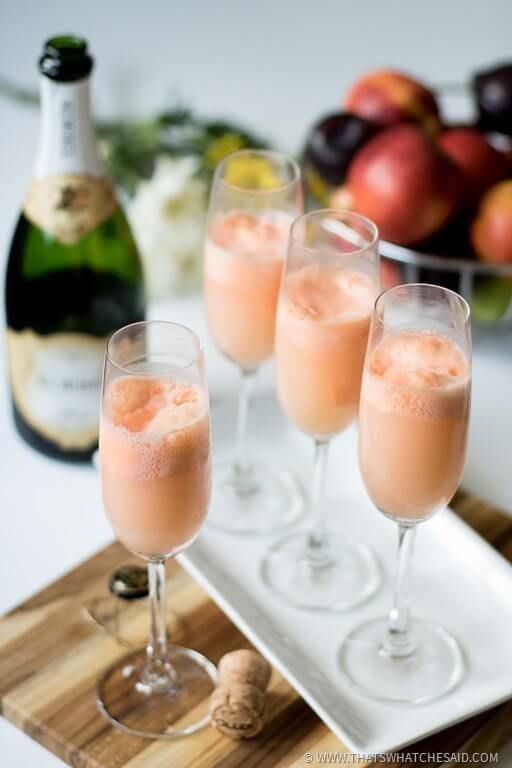 three wine glasses filled with champagne on a tray